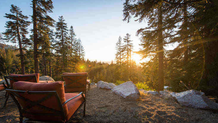 Chairs outside overlooking mountains.