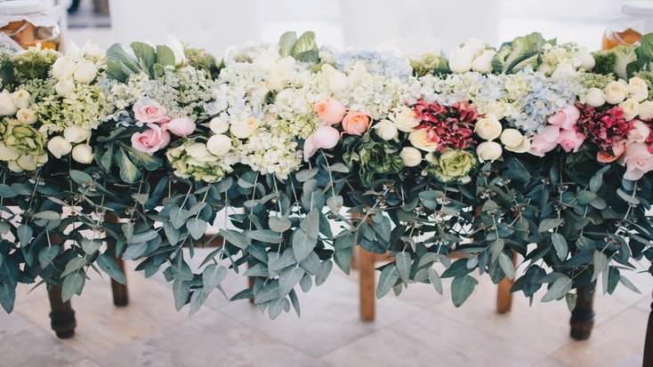 A row of bouquets at a spring wedding and outdoor wedding venue.