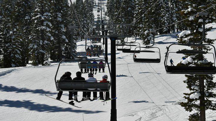 Discover montana glamping while on your ski vacation, like these people on ski lift 