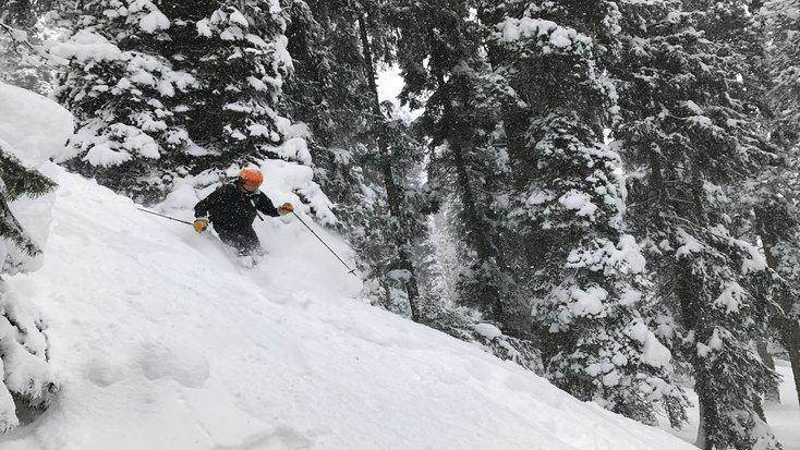 Man skiing down slopes after spending morning in one of the best winter cabins in Colorado 