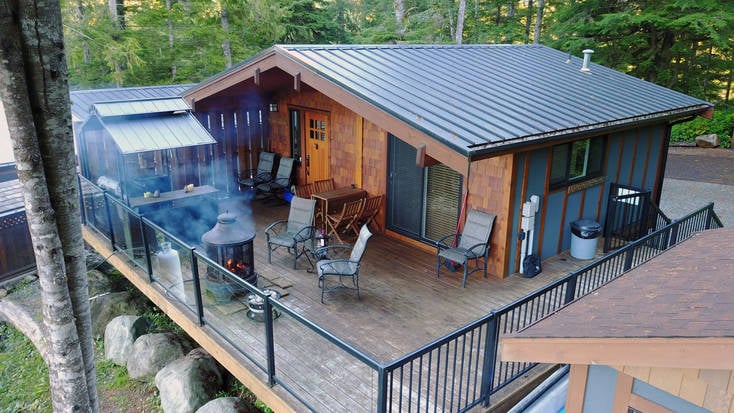 Aerial shot of a BC cabin rental with a hot tub and grill.