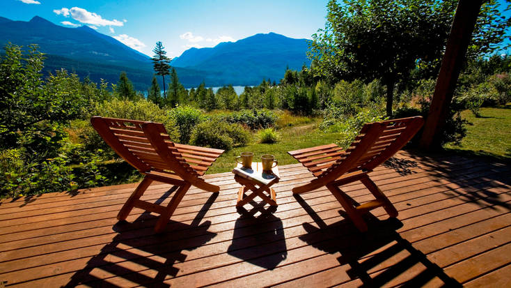 Two adirondack chairs overlooking Kootenay Lake, British Columbia