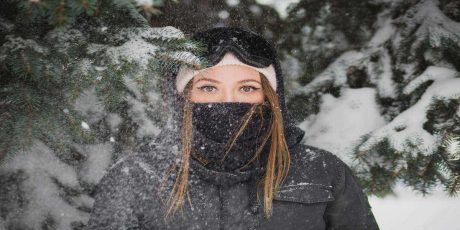 Image of girl wearing some of the best winter essentials for outdoor luxury camping