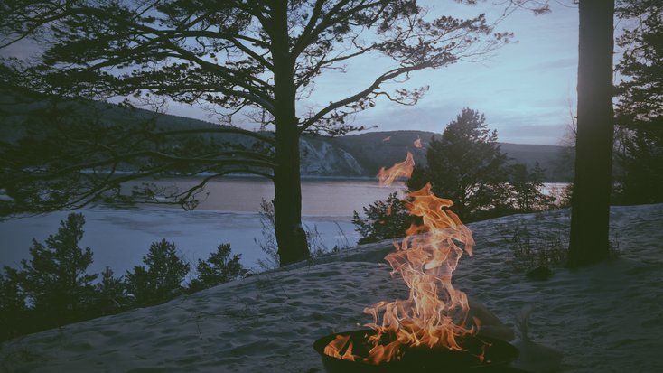 Fire in the forest, lit by people on a trip as part of the best east coast vacations fir couples in winter 