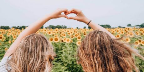 Two women in a field of sunflowers, single on Valentine's Day