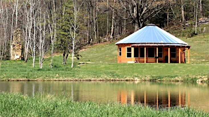 yurt-shaped cabin with fishing pond and forest background, Virginia