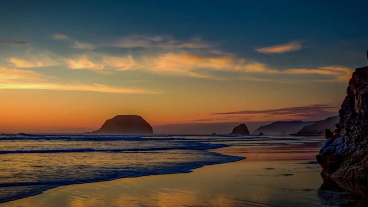 Plan a couple's getaway in Oregon and enjoy sunsets over Cannon Beach