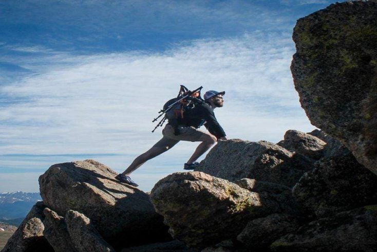man climbing rocks in Julian, California during trip