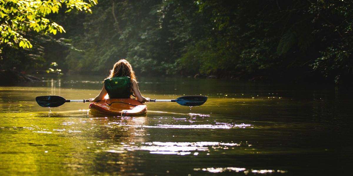 Woman kayaking during glamping washington trip for long weekends 2020 luxury camping