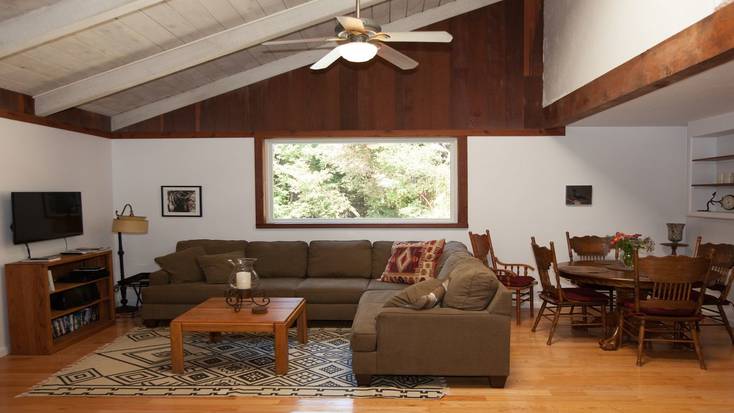Living room with a large sofa in a cabin on the Big Sur coast