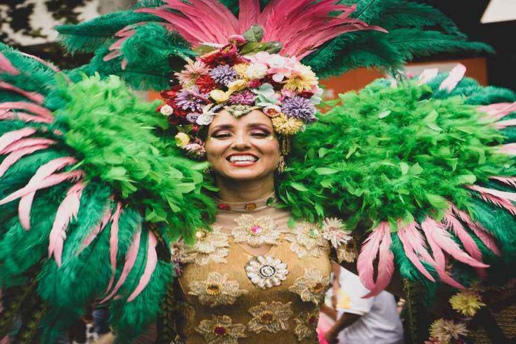 Woman enjoying Mardi Gras festival dressed in traditional costume for New Orleans parade