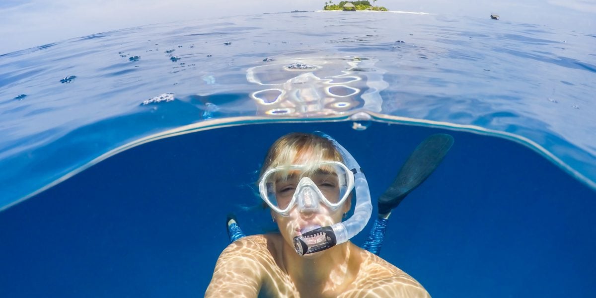 woman enjoying marine life from one of the most beautiful beaches in the world