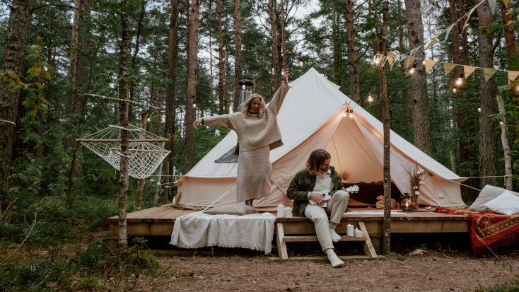 couple relaxing in a bell tent with hammock