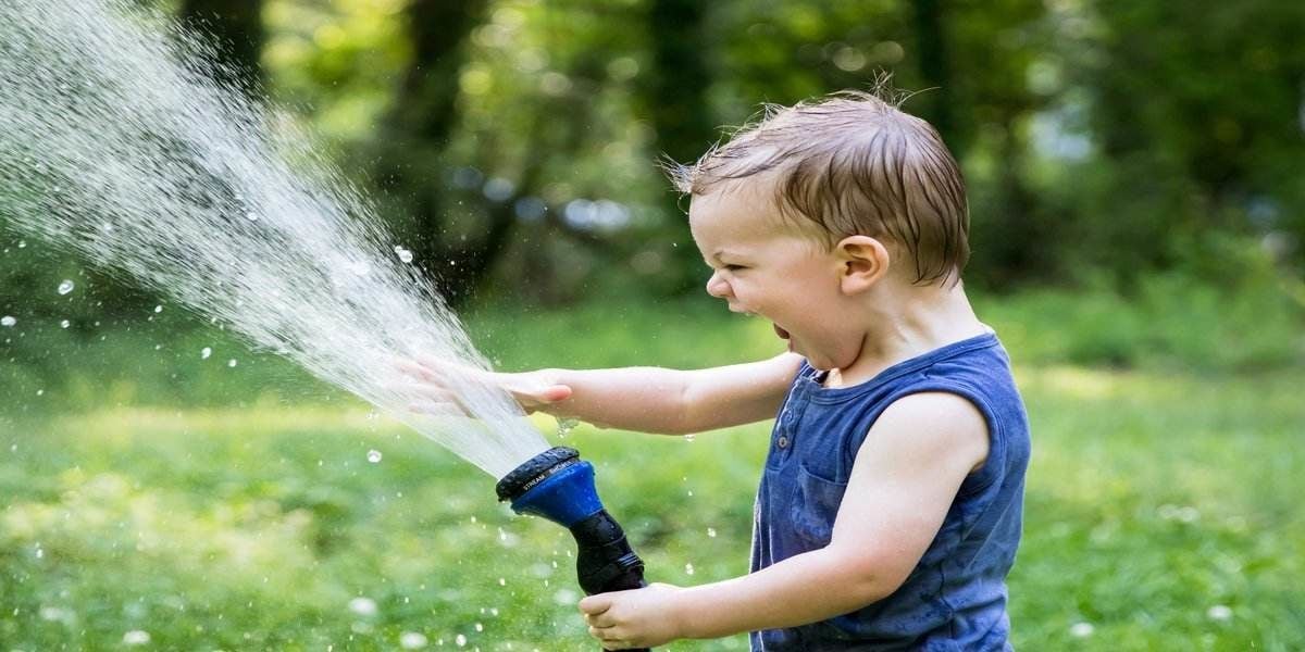 child enjoying playing outside during summer family vacation