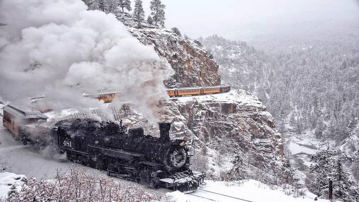 The Polar Express makes its way through the snow covered mountains