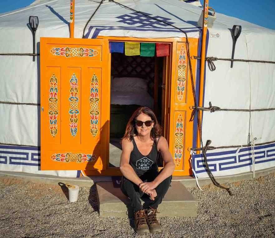 Erin, one of the inspirational women we work with, sitting outside one of the yurts