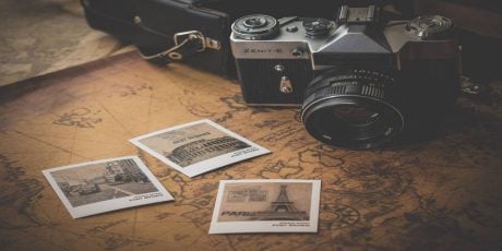 A camera, a map, and vacation photos .