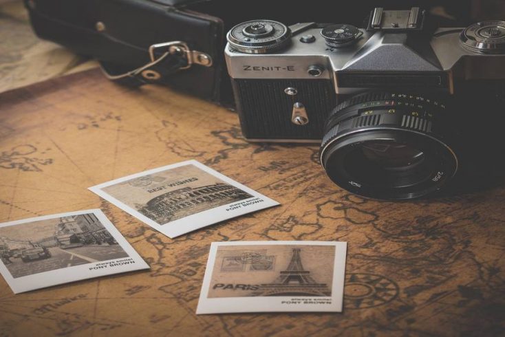A camera, a map, and vacation photos .