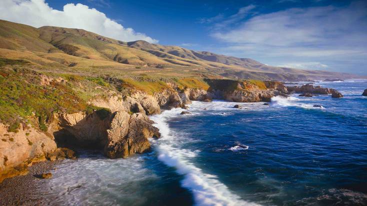 Central Coast, California with waves  Of crashing against the rocky shoreline.