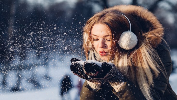 Woman wearing protection for winter, essentials for those looking to protect ears with earmuffs 