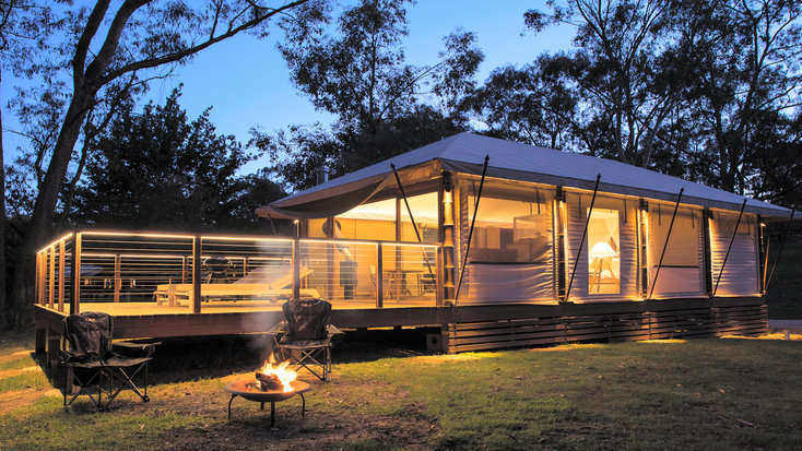 A safari tent illuminated at dusk in the Blue Mountains, NSW.