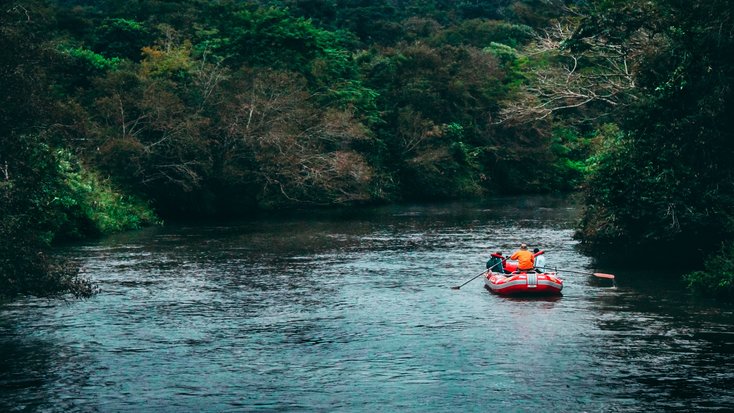 People rafting on a river on a college spring break.