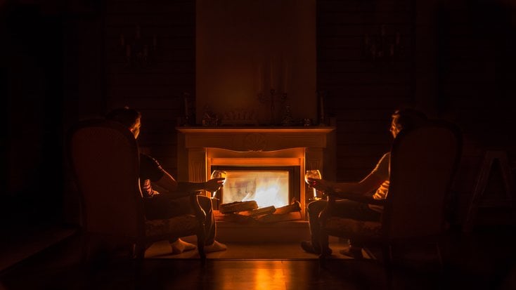 A man and woman sit side by side on couples vacation luxury camping for Presidents' Day Weekend 