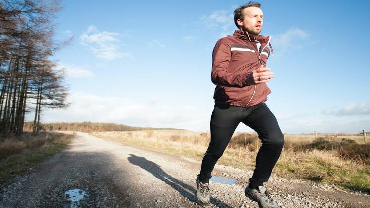 A man running alone in the countryside