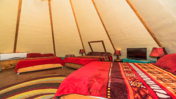 Three queen-size beds in one of the tipi rentals