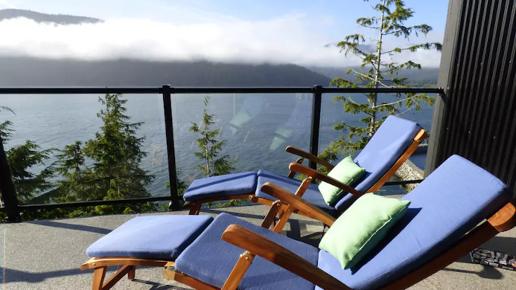 blue deck chairs with green cushions over looking the bay, BC