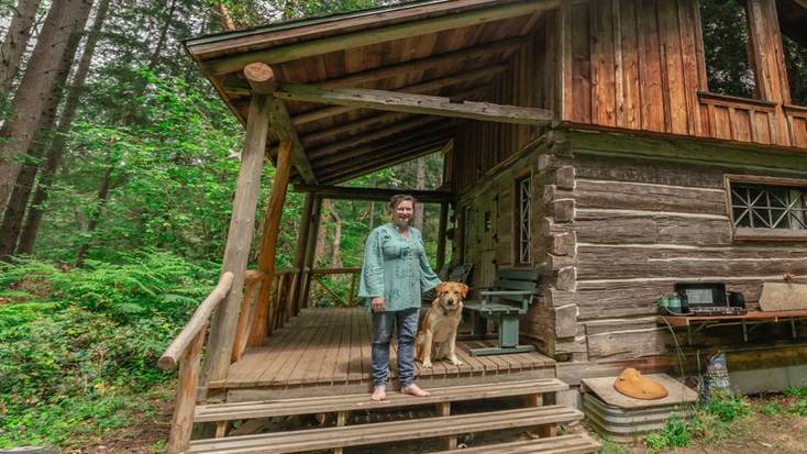 One of our female hosts, Catherine, outside her cabin with her dog