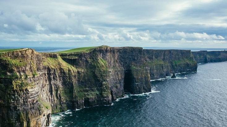 Visit the Cliffs of Moher during a summer vacation in Ireland