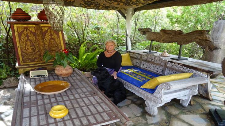 Daria and her dog relaxing in one of the outdoor areas of her couple's retreat in Casares 