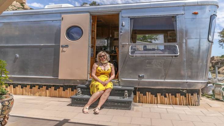 One of our female hosts of the month, Julia on the step of her travel trailer