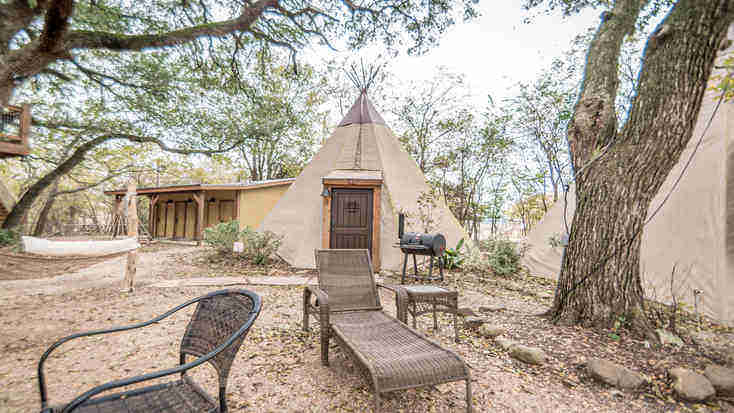 A sun lounger outside a tipi rental