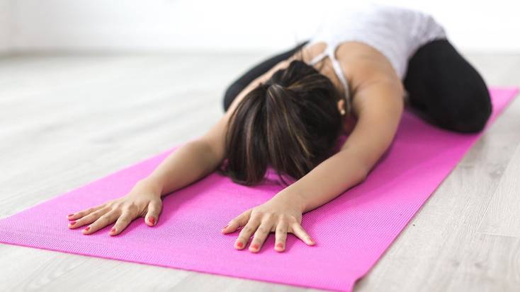 Yoga pose on pink yoga mat