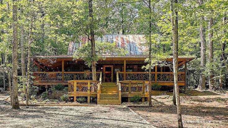 A secluded cabin in the woods with two front decks