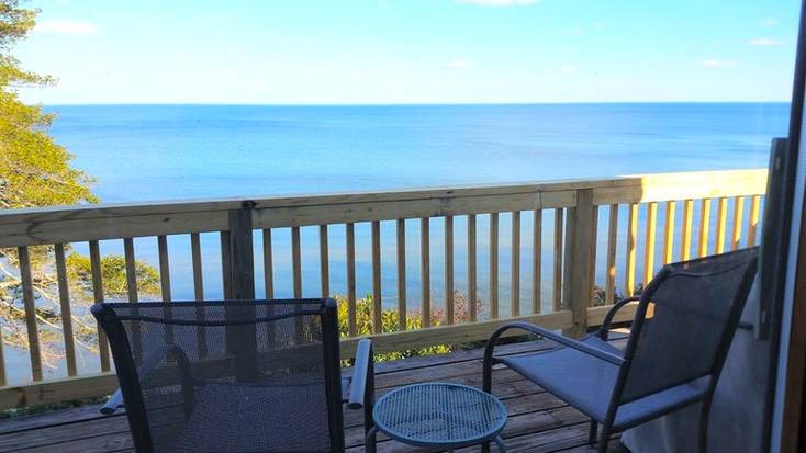 A balcony with deck chairs overlooking the ocean in Maryland.