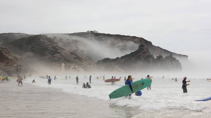 Surfers on the beach at Praia do Amado, Portugal