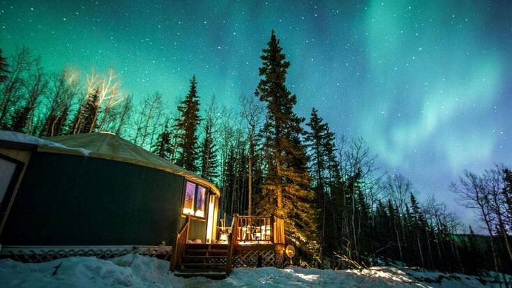 The Northern Lights over a yurt near Fairbanks for the perfect family vacation in Alaska