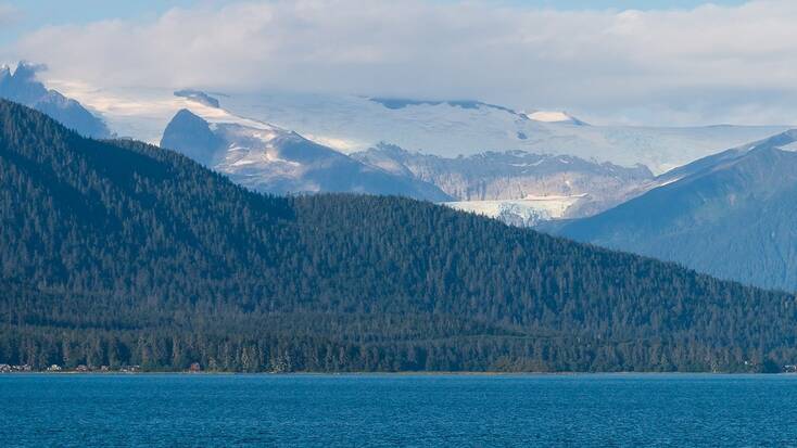 A view of a lake, mountains, and a forest near Juneau, Alaska