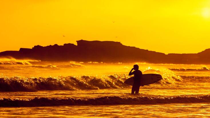 Someone surfing at sunset in Baja California