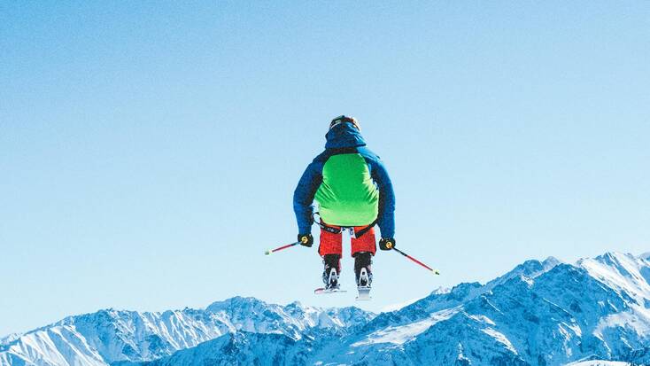 A skier attempting a ski jump