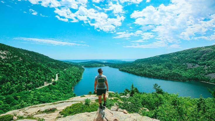 A hiker admiring the views in Acadia National Park