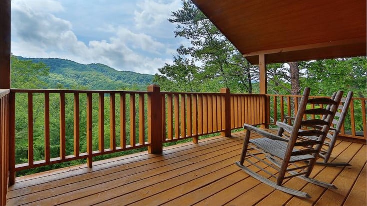 private deck with forest views, deck chairs and hot tub