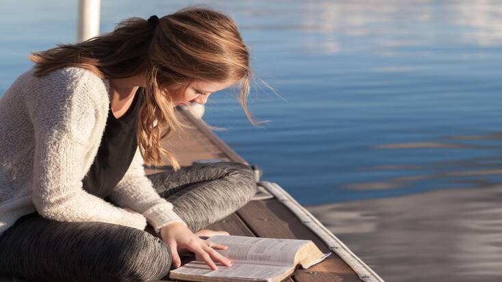 A reader with one of the best travel books to celebrate World Book Day