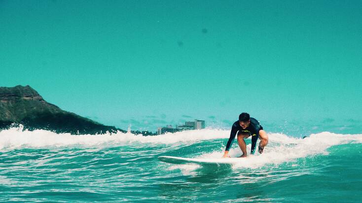 A man surfing in Hawaii