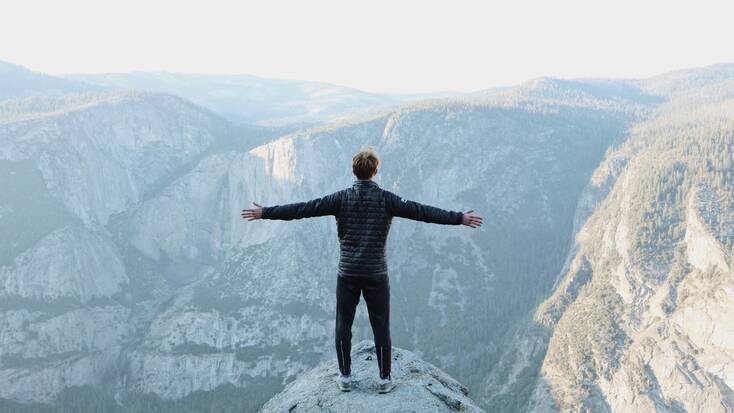 A hiker admiring the view over the  Sierra National Forest