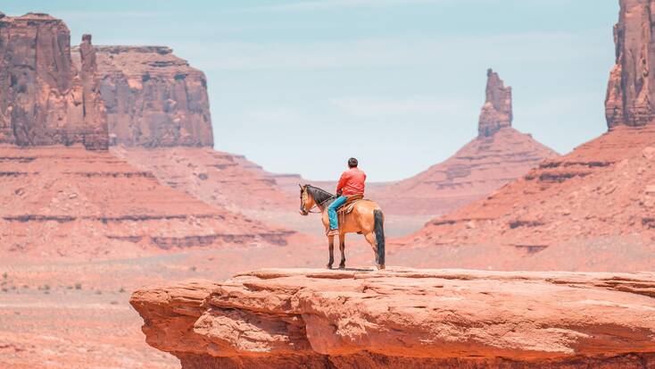 A man on a horse in Monument Valley, one of the best things to do in Arizona