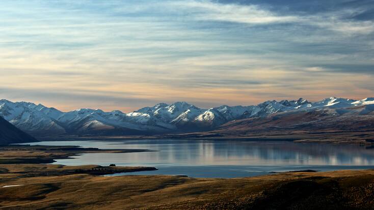 A secluded lake with a mountain range in the horizon